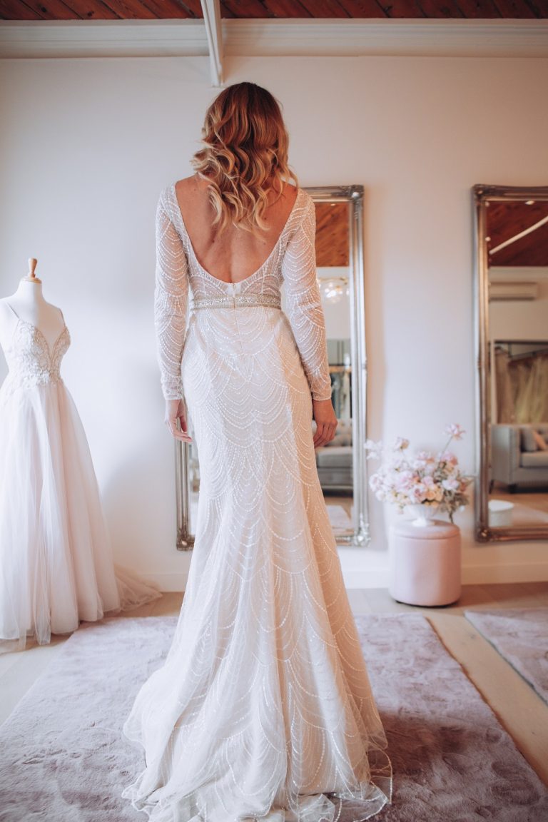 The back of a woman wearing a wedding dress in the Oleg Cassini Melbourne showroom 768x1152