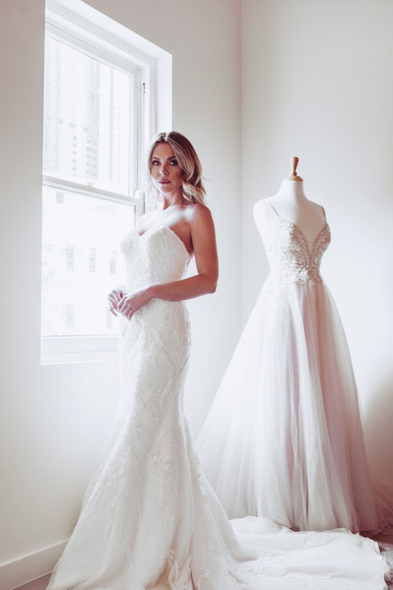 Woman wearing a wedding dress in the Oleg Cassini Melbourne showroom 768x1152