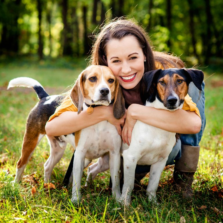 Woman and two dogs posing 768x768