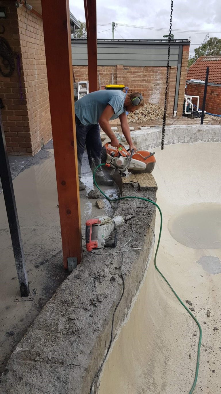 Demo saw cutting pebble off pool shell 768x1366