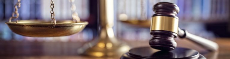 beachside legal judge gavel scales of justice and law books in court 1920x570 1 768x197