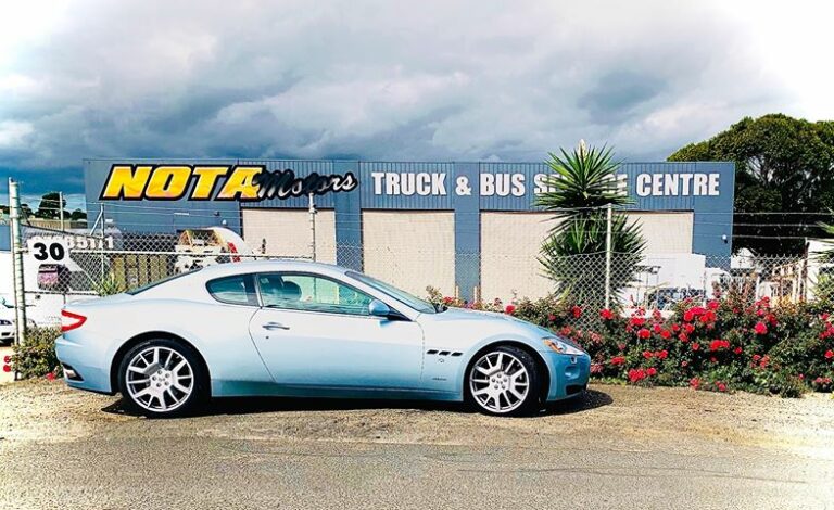 car infront of signage 768x470