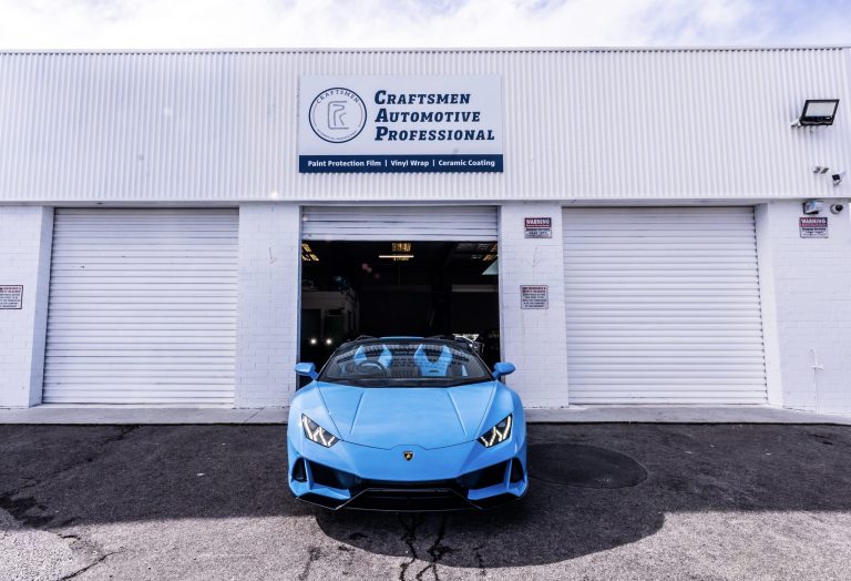 craftsmen automotive professionals paint protection services on blue lamborghini out side auto shop 768x524