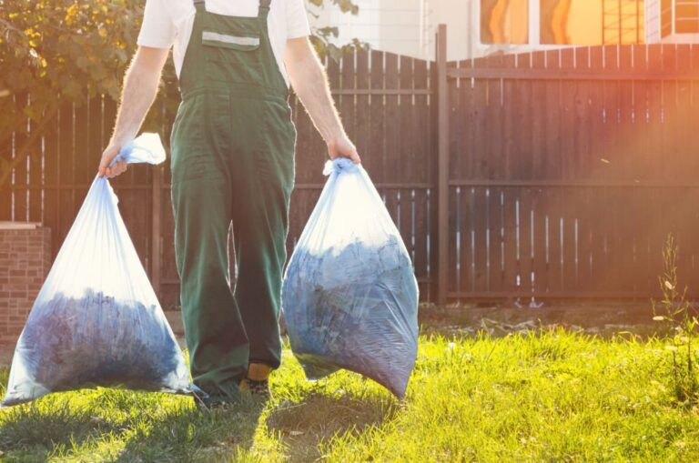 Close up of the gardener in the hands of bags of compost 768x509